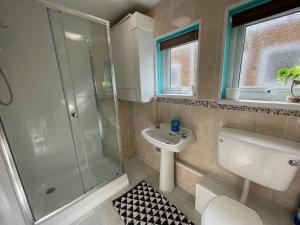a bathroom with a shower and a sink and a toilet at 119 Hemsby Holiday Chalet, Convenient for sandy beach in Hemsby