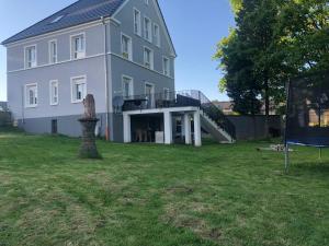 a large white house with a large yard at Mein Eifel Ferienhaus Altes Pfarrhaus in Dahlem