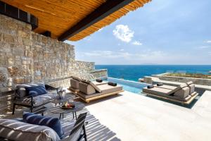 a patio with furniture and a view of the ocean at Tropicana Hotel , Suites & Villas Mykonos in Paradise Beach