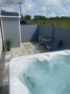 a hot tub in a backyard with a table and chairs at Scenic Retreat in Felton