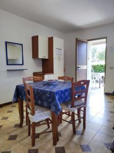 a dining room with a blue table and chairs at Casa Relax Acqua Marina in Favignana