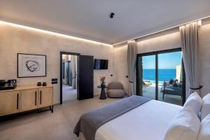 a bedroom with a bed and a view of the ocean at Tropicana Hotel , Suites & Villas Mykonos in Paradise Beach