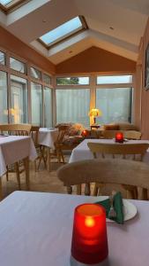 a dining room with tables and chairs and a skylight at Atlantic Lodge in Galway