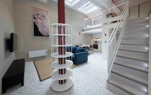 a spiral staircase in a room with a living room at Trueman Court Luxury Serviced Apartments in Liverpool