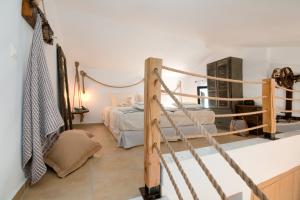 a bedroom with a bunk bed and a couple of beds at Seathon SeaFront Beach Villa in Kalamitsi in Kalamitsi