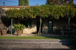 a stone house with trees and a patio at Espectacular villa en Mondariz, Casa Mirabal in Pontevedra