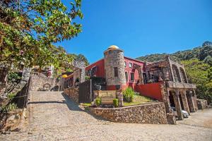 un edificio con una torre al lado de una carretera en Hotel Boutique Hacienda Caudillos, en San Sebastián del Oeste