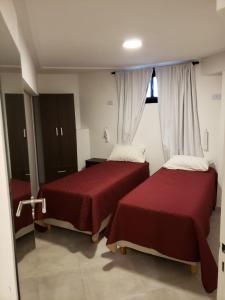 Postel nebo postele na pokoji v ubytování Ganesha Abasto Apartments + 23 fotografií
