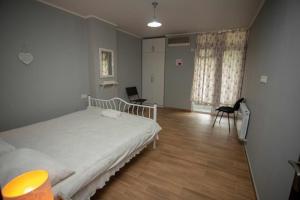 a hospital room with a bed and a chair at Amazing Magnolia in Batumi