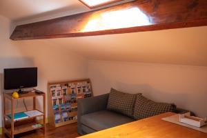 a living room with a couch and a television at Casadangra, bnb in Angra do Heroísmo