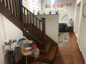 a stairway with a chair and a stair case at Hostel Ipê in Sao Paulo