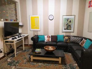 a living room filled with furniture and a tv at Hostel Ipê in Sao Paulo