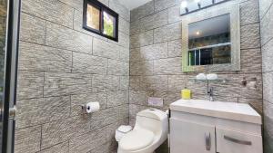 a bathroom with a toilet and a sink at The Residence by Villa Alejandro in Boquete +39 photos