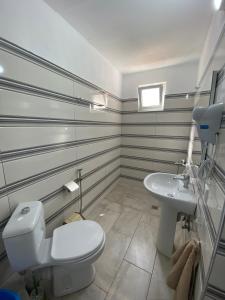 a bathroom with a toilet and a sink at Full Moon Apartments in Ksamil