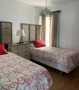 1 dormitorio con 2 camas, vestidor y ventana en Casa el Jable, en Arrecife