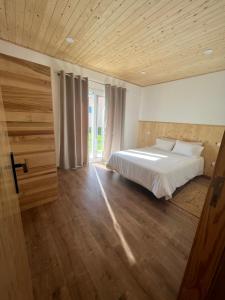 a bedroom with a bed and a wooden ceiling at Forno House - Ameixoeira in Vila Praia de Âncora +16 photos