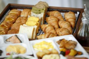 a tray filled with different types of bread and pastries at Hotel Monterey Himeji in Himeji