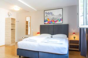 a bedroom with a large white bed in a room at St Christopher's Vienna in Vienna