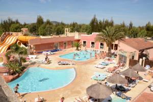 a large pool at a resort with people in it at Camping Les Palmiers in Hyères