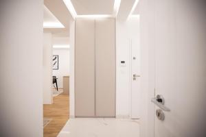 a hallway with white walls and a door in a room at Olive Residence in Zadar +84 photos