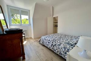 a bedroom with a bed and a window at La Triolette, maison chaleureuse, indépendante et refaite à neuf dans le Vieux Coutainville, tourisme ou télétravail in Agon-Coutainville