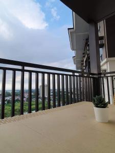 a balcony of a building with a potted plant at Kasa Bae in Tagaytay