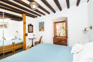 a bedroom with a blue bed and a window at Apartment Rustika in Skradin