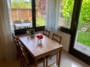 una mesa de madera con un jarrón de flores. en Big Apartment with garden Rapperswil-Jona en Jona