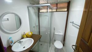 a bathroom with a shower and a sink and a toilet at Condomínio Eco Resort Lençóis in Barreirinhas +23 photos