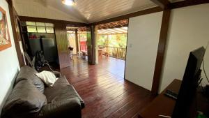 a living room with a couch and a wooden floor at Condomínio Eco Resort Lençóis in Barreirinhas