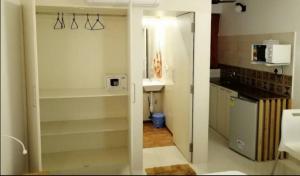 a bathroom with a sink and a kitchen with a mirror at Cassiopeia Nest in Arambol +31 photos