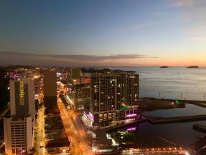 a view of a city at night with buildings at Sunset Seaview Vacation Condos @ Jesselton Quay in Kota Kinabalu