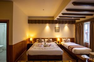 Rúm í herbergi á Siddhartha Boutique Hotel, Boudha