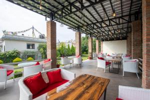 an outdoor patio with tables and chairs and a wooden table at Siddhartha Boutique Hotel, Boudha in Kathmandu