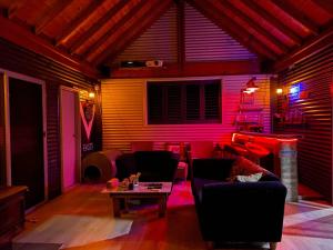 a living room with a couch and a table at Brett's Rest Nel in Kingscote