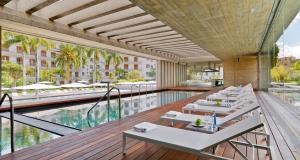 a hotel with a pool and tables and a swimming pool at Iberostar Heritage Grand Mencey in Santa Cruz de Tenerife
