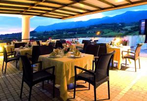 a restaurant with tables and chairs with a view at Hotel Michelangelo Palace & SPA in Terni