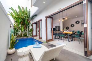 ein Wohnzimmer mit einem Pool in einem Haus in der Unterkunft Villa Alhena in Canggu