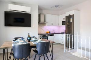 a kitchen with a table and chairs and a refrigerator at AXS First Floor Apartment Aegina Town in Aegina Town +25 photos