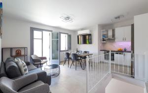 a living room and kitchen with a couch and a table at AXS Top Floor Apartment in Aegina Town