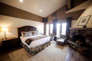 a bedroom with a large bed and a fireplace at Deer Valley Two Bedroom Loft Suite with Easy Access to all Park City has to Offer condo in Park City