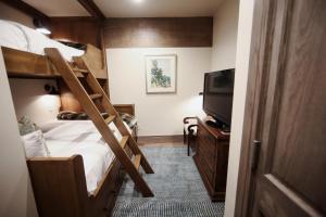 a bedroom with a bunk bed and a flat screen tv at Deer Valley Two Bedroom Loft Suite with Easy Access to all Park City has to Offer condo in Park City