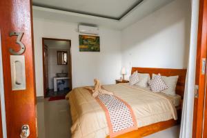 Postel nebo postele na pokoji v ubytování The Gria Unique Ubud