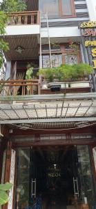 a man standing on the balcony of a building at Phố Seoul Homestay And Spa in Hoi An