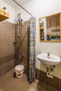 a bathroom with a sink and a shower at Stunning urban view at Vista Heights Legarda in Manila