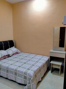 sypialnia z łóżkiem i telewizorem w obiekcie Rahman Homestay Pantai Johor - ISLAM SAHAJA w mieście Alor Setar