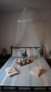 a bed with two towels and a tray on it at Artemis House in Agios Nikolaos