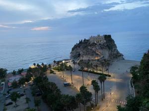 a castle on top of a rock in the ocean at The world suite in Tropea