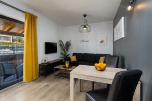 a living room with a table and a couch at Apartments Residence Radovan 1 in Poreč