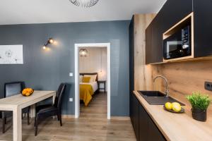 a kitchen and dining room with a bed in a room at Apartments Residence Radovan 1 in Poreč